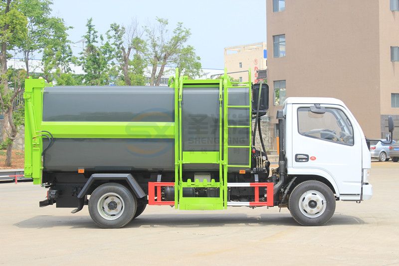 藍(lán)牌7.5方東風(fēng)多利卡壓縮式掛桶垃圾車(chē)